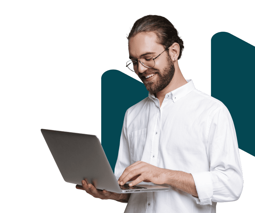 a guy holding his laptop on one hand and typing with the other hand