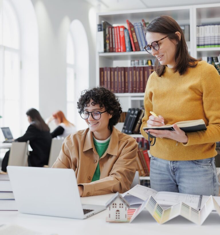 two girls watching a laptop