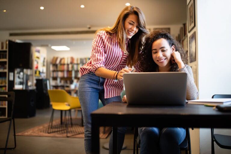two girls on a laptop
